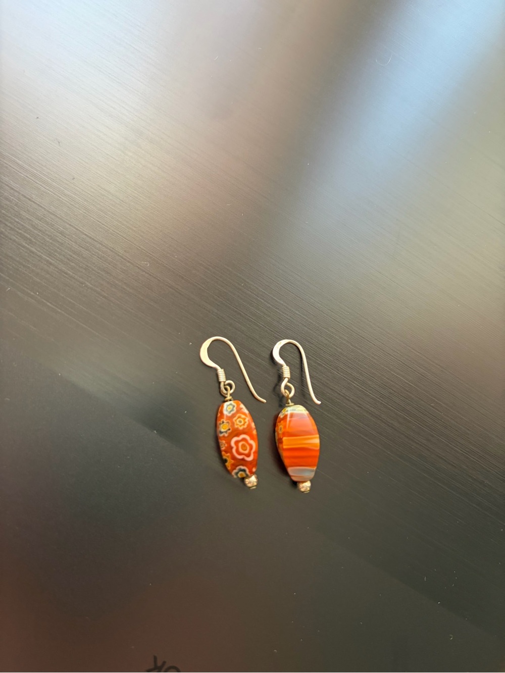 Orange Earrings on silver metal